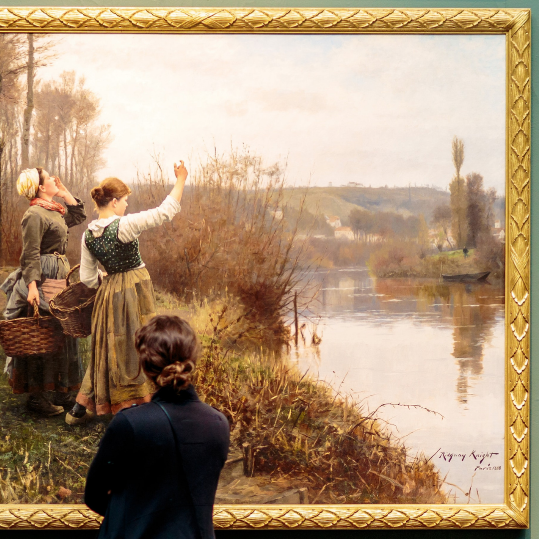 A visitor standing in front of a painting titled Hailing the Ferry, painted in 1888 by the American artist Daniel Ridgway Knight.