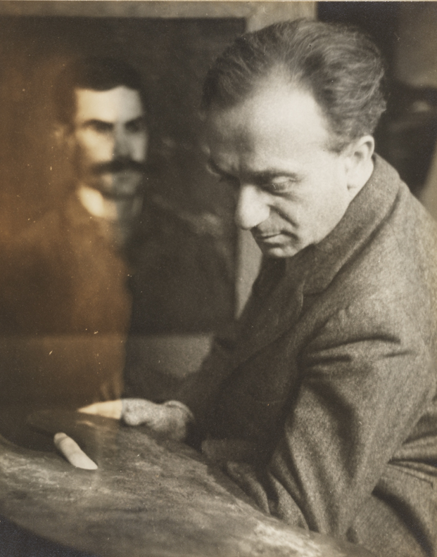 Julius Bloch posing in front of Eakin's portrait of Frank Macdowell