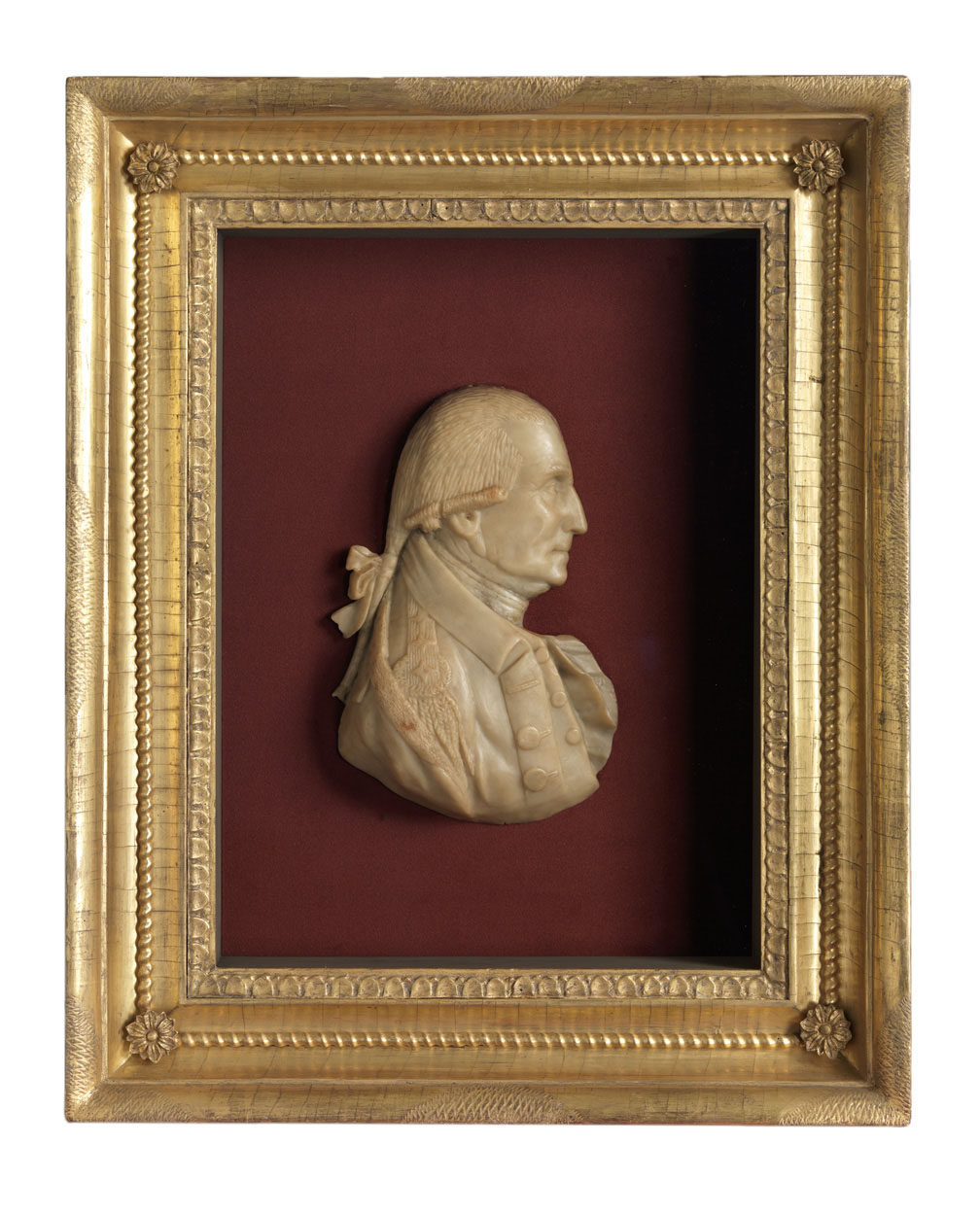 Portrait of George Washington in an ornate gold frame, showcasing his dignified expression and historical significance.