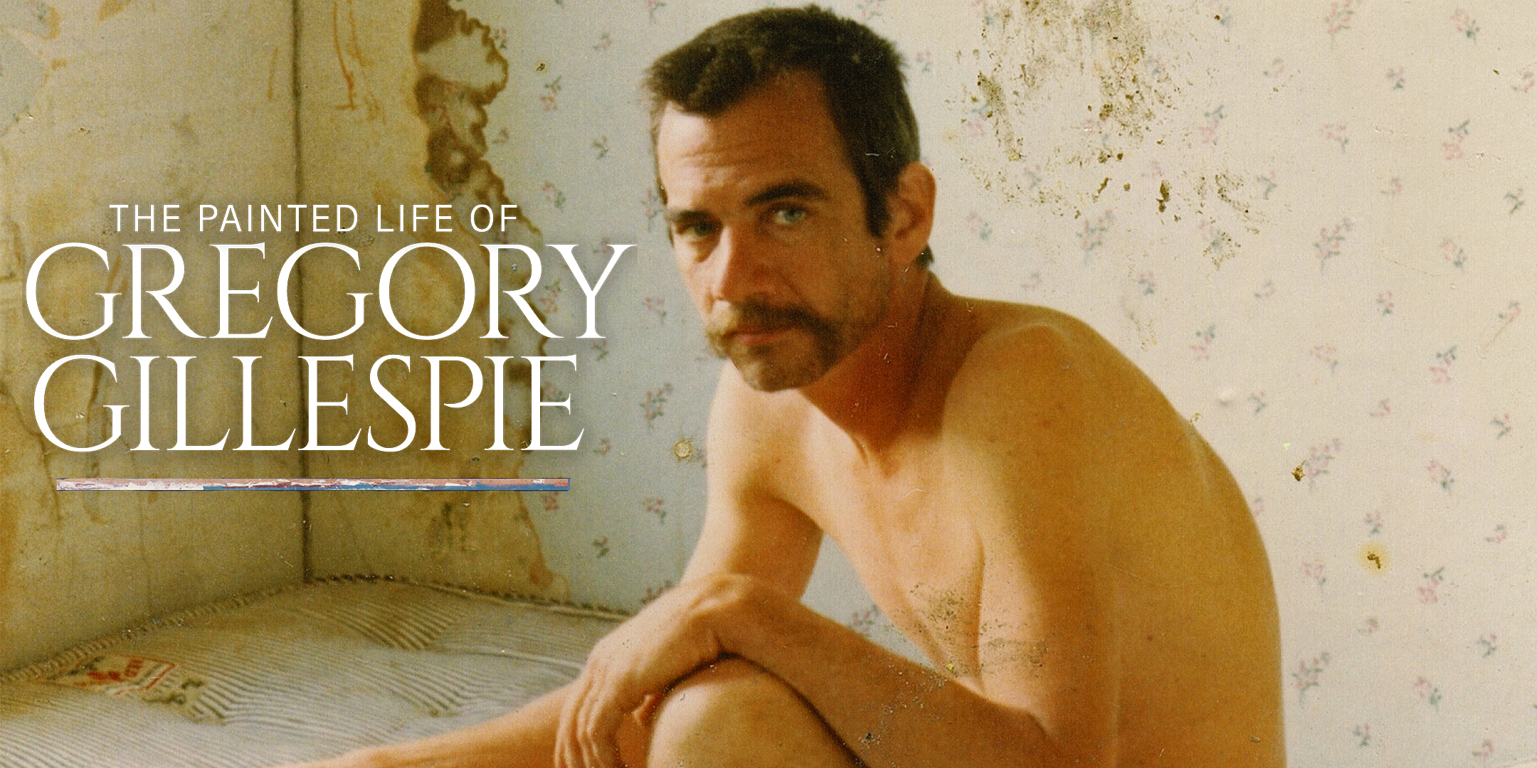 A title card for the documentary film The Painted Life of Gregory Gillespie, featuring a photograph of the subject, a shirtless man with a mustache, sitting in a worn room and looking at the camera.