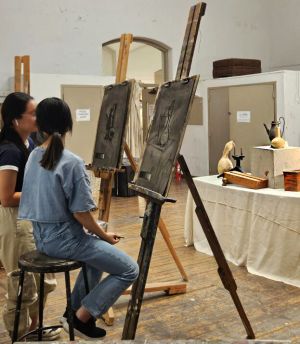 students in studio with easels