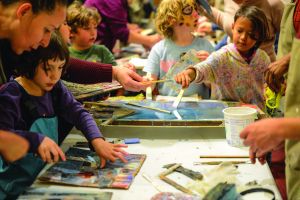 group of children and their families doing art activities