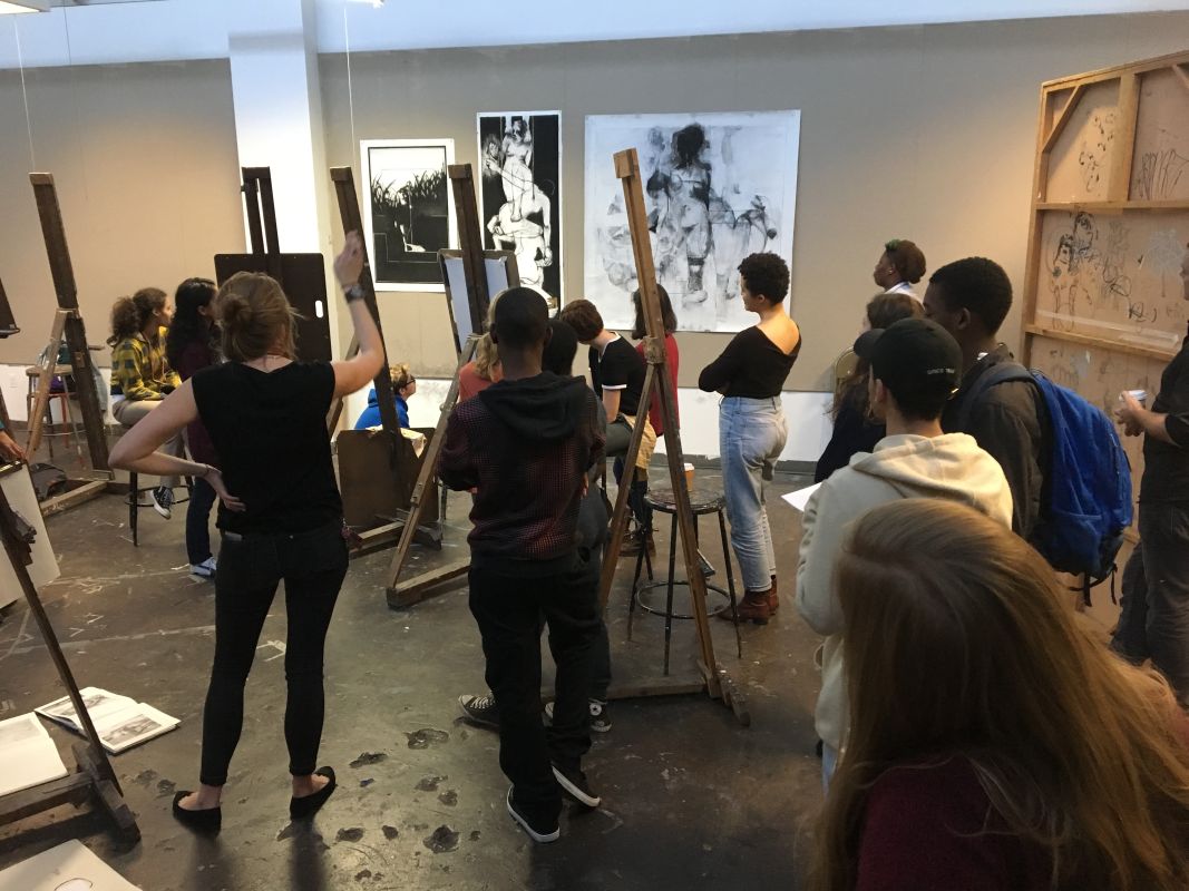 Students focused on artworks at the front of the room