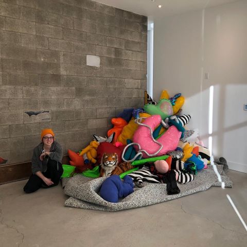 ashley garner poses with one of her soft sculptures