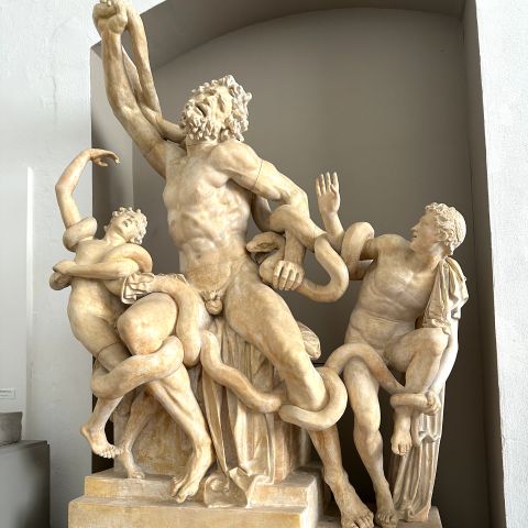 Cast of the sculpture Laocoön featuring the titular figure at center flanked by his sons.