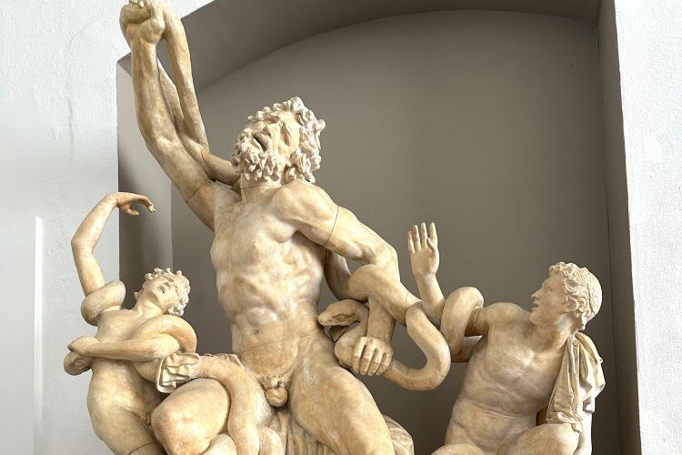 Cast of the sculpture Laocoön featuring the titular figure at center flanked by his sons.